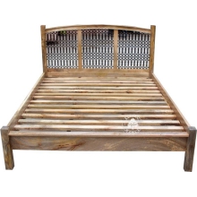 Łóżko z drewna z ozdobnymi panelami z kutego metalu